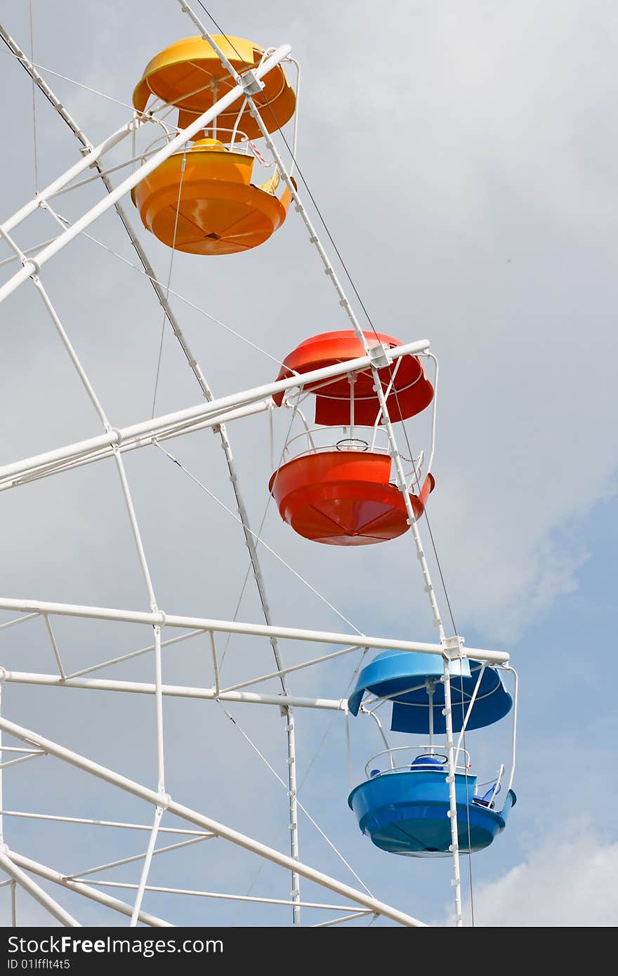 Three multi-coloured booths on a big wheel. Three multi-coloured booths on a big wheel