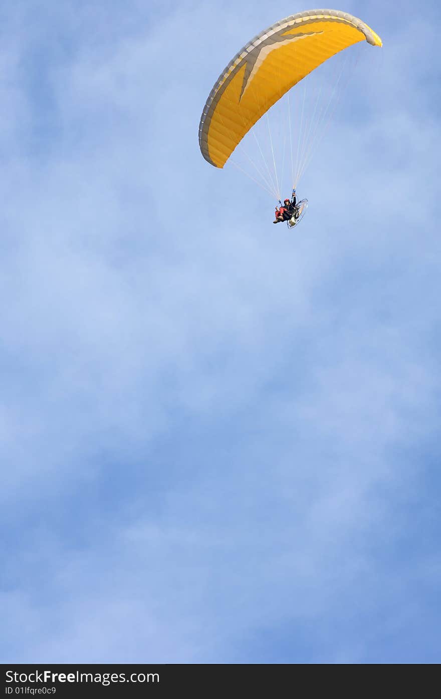 Orange paramotoring with blue sky