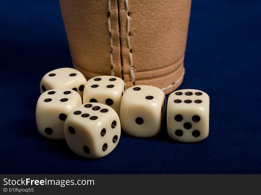 Dice cup and dice on background