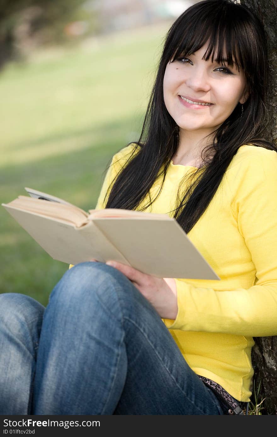 Casual woman reading book in park