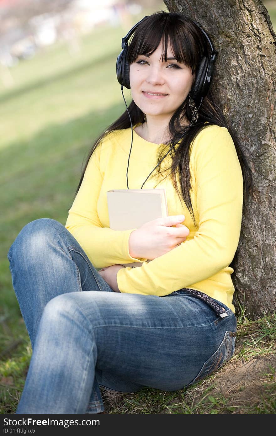 Casual woman reading book in park