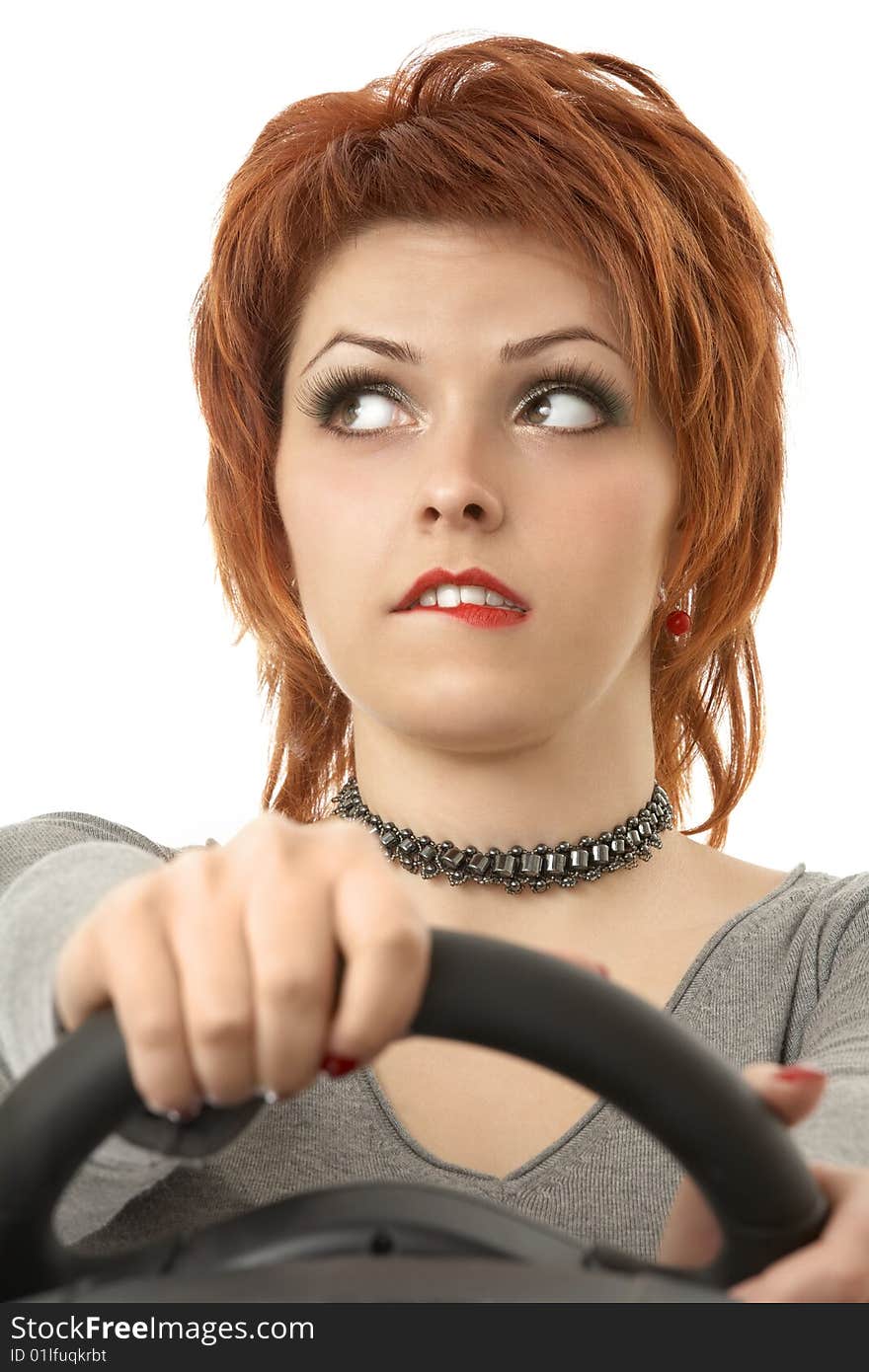 Portrait of the thoughtful woman at the wheel an autosimulator, isolated. Portrait of the thoughtful woman at the wheel an autosimulator, isolated