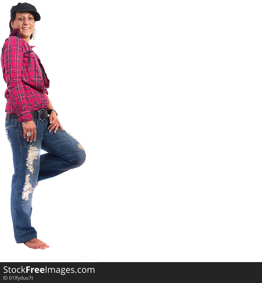 Portrait of a young woman wearing a pink shirt and ripped blue jeans.