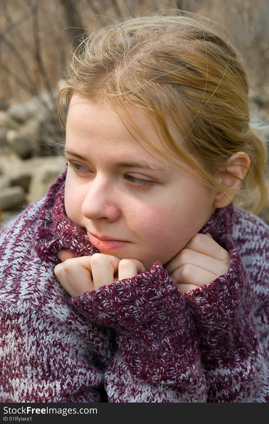 A portrait close-up of the girl in sweater. A portrait close-up of the girl in sweater.