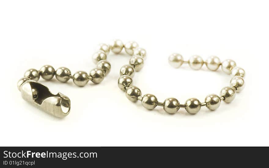 Short small ball chain arranged as snake isolated on white background. Short small ball chain arranged as snake isolated on white background