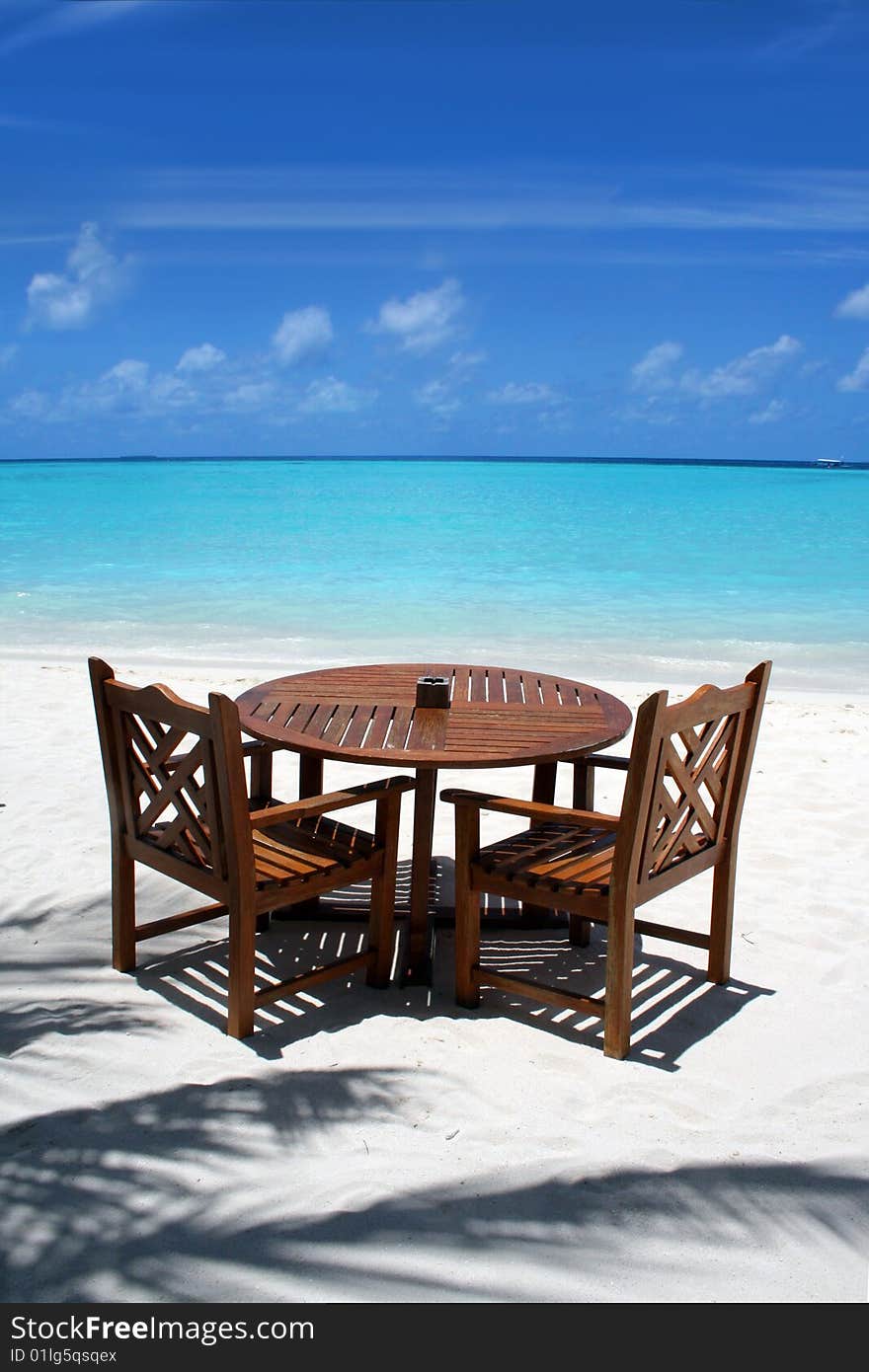 Table and chairs on exotic beach. Table and chairs on exotic beach