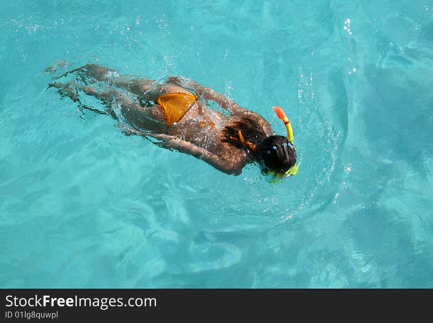 The girl snorkeling in blue watersnorkeling