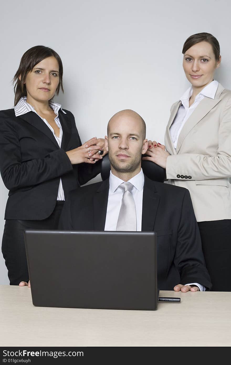 Young businessteam of three persons with a bossy executive