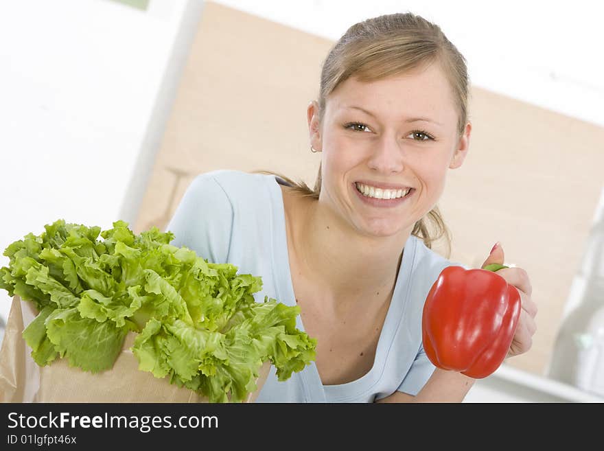 Beautiful young woman making vegetarian vegetable salad. Beautiful young woman making vegetarian vegetable salad