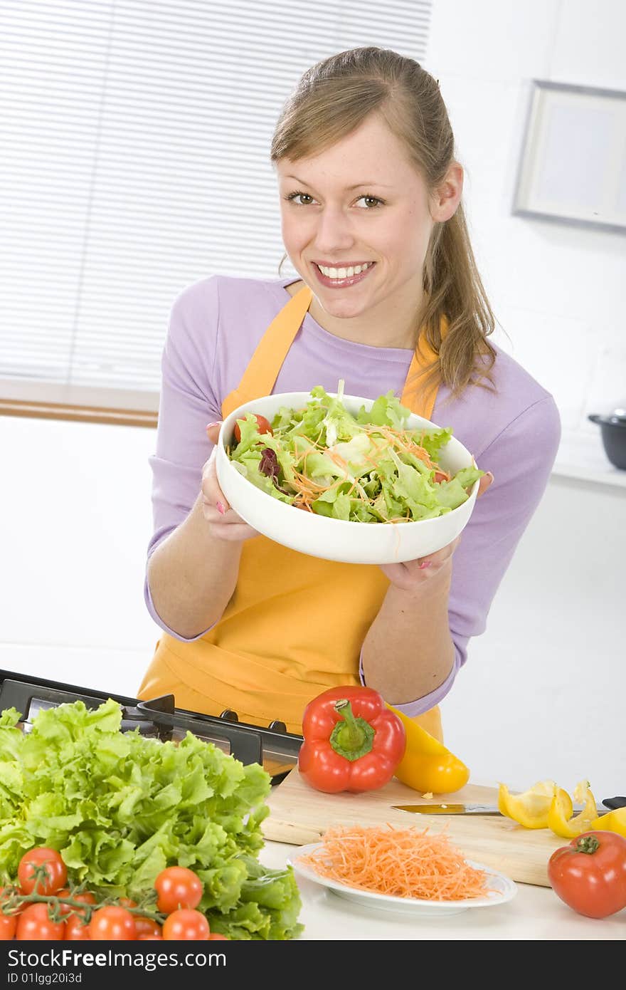 Beautiful young woman making vegetarian vegetable salad. Beautiful young woman making vegetarian vegetable salad