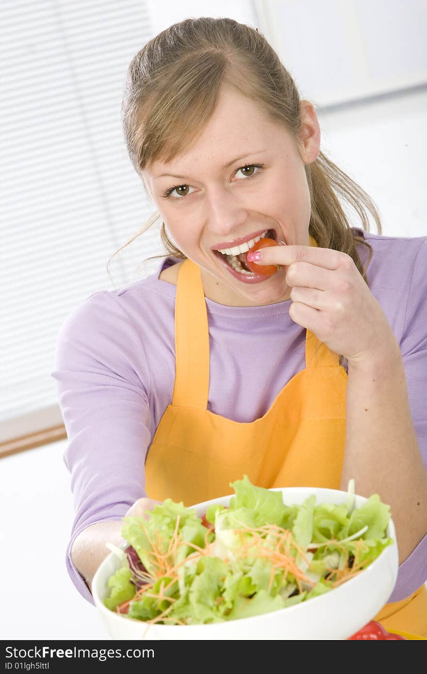 Beautiful young woman making vegetarian vegetable salad. Beautiful young woman making vegetarian vegetable salad