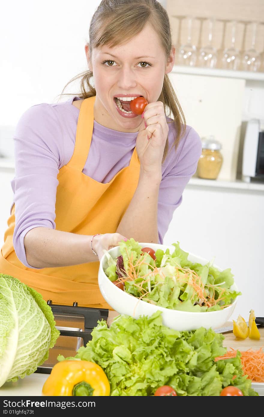 Beautiful young woman making vegetarian vegetable salad. Beautiful young woman making vegetarian vegetable salad