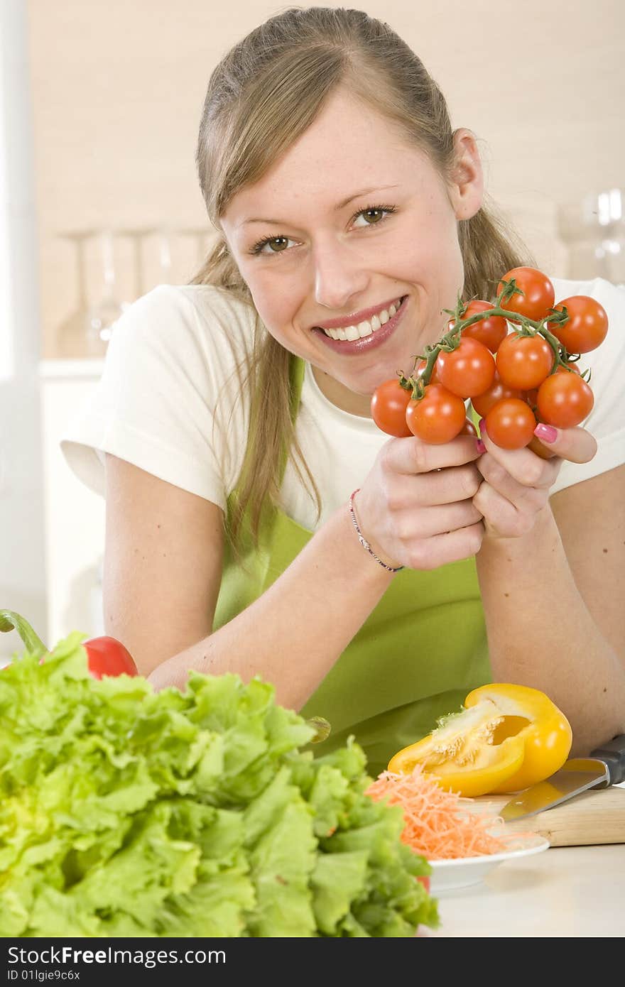 Beautiful young woman making vegetarian vegetable salad. Beautiful young woman making vegetarian vegetable salad