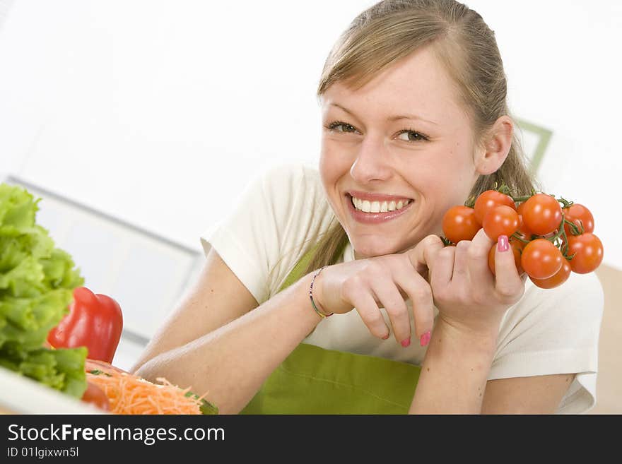 Beautiful young woman making vegetarian vegetable salad. Beautiful young woman making vegetarian vegetable salad