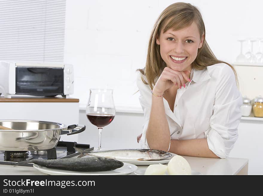 Women in kitchen with glass of wine. Women in kitchen with glass of wine