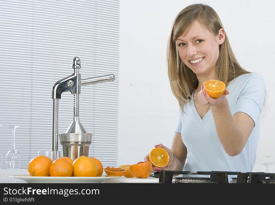 Girl In The Kitchen With Juicy Orange