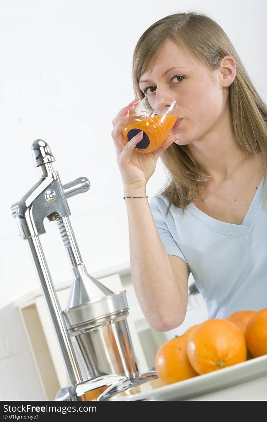 Girl In The Kitchen With Juicy Orange