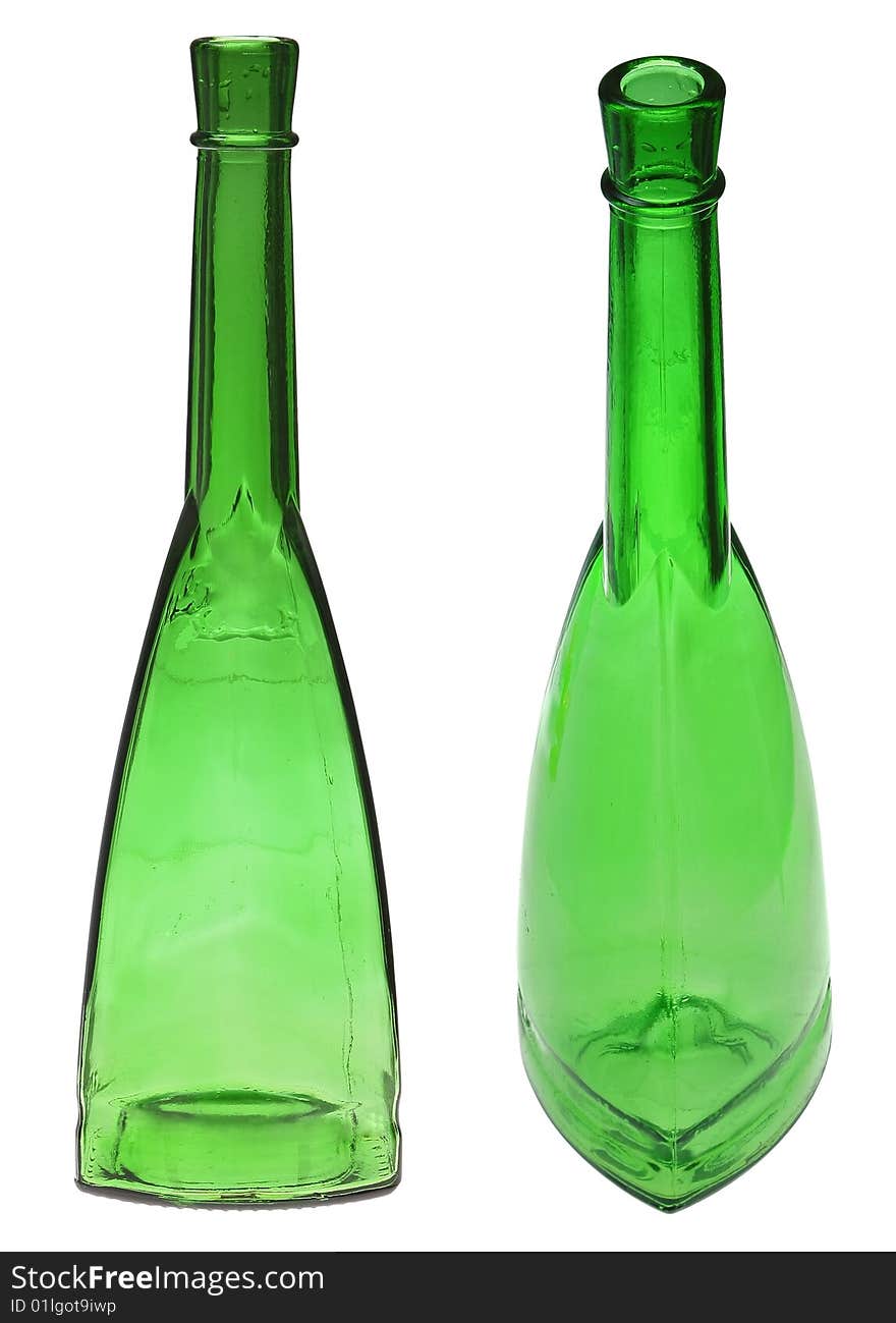 Green glass bottles on the white. Green glass bottles on the white