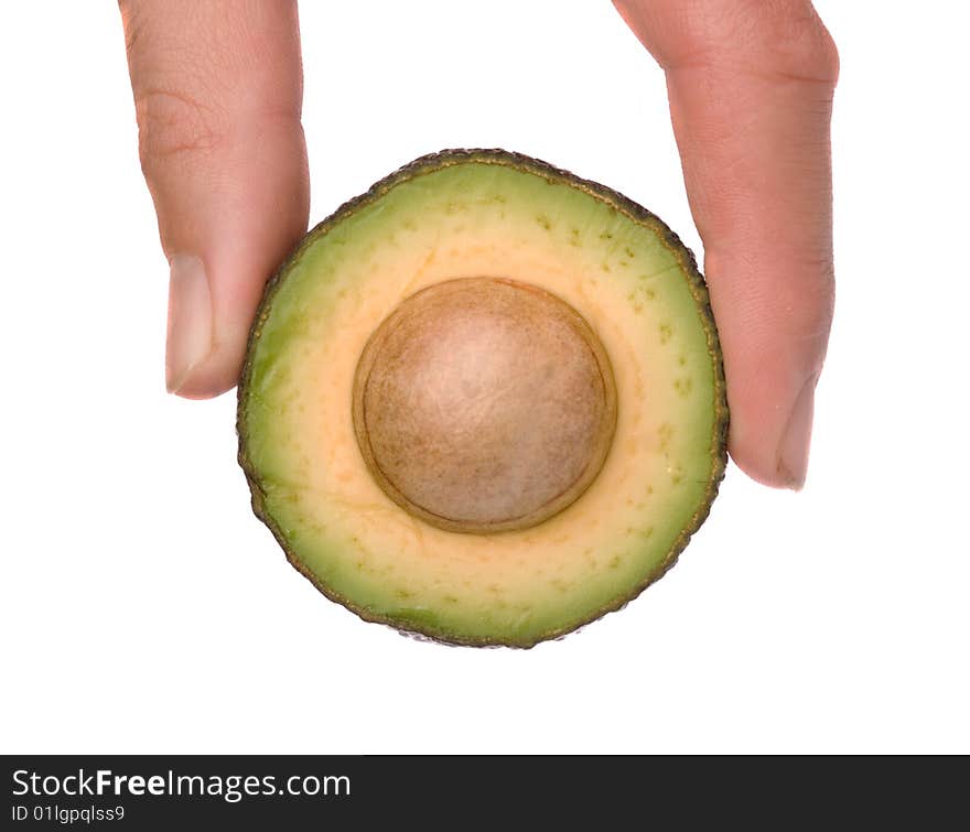 Hand holding section of acocado