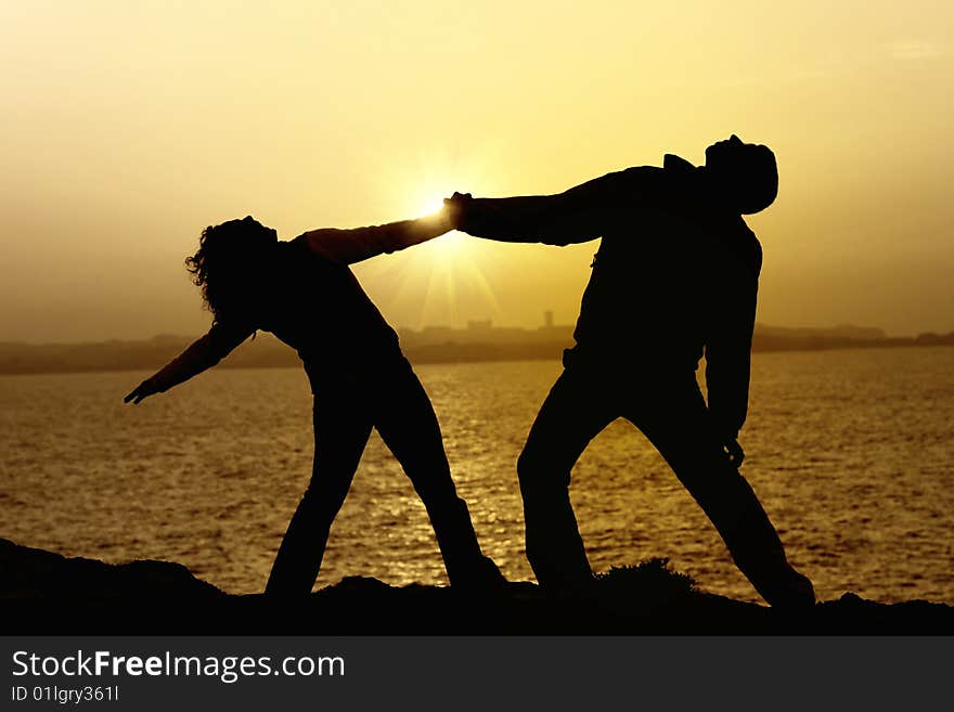 Couple at sunset with a city in the background