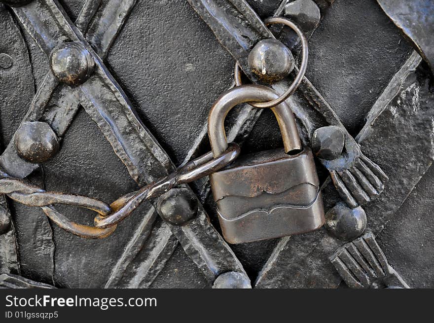 Old padlock on iron door