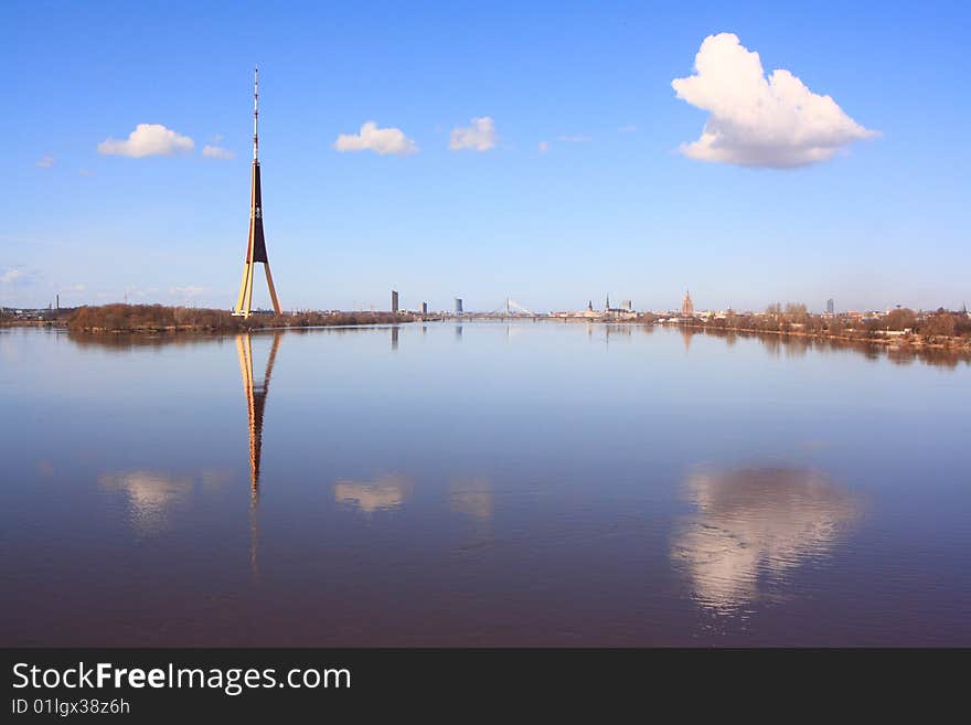 Panorama of Riga with reflection of clouds in water. Panorama of Riga with reflection of clouds in water