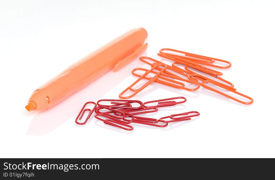 Orange highlighter pen with orange and red paper clips. Orange highlighter pen with orange and red paper clips