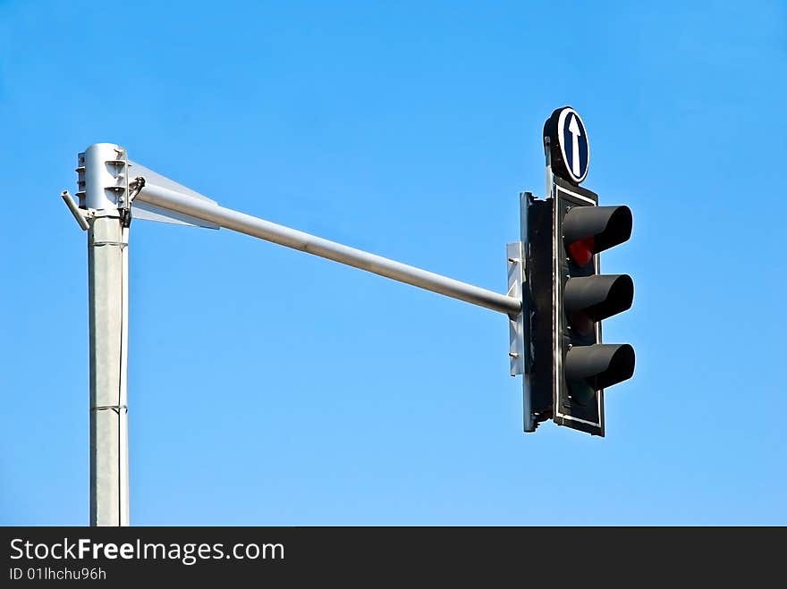 Traffic light on red isolated on blue background.