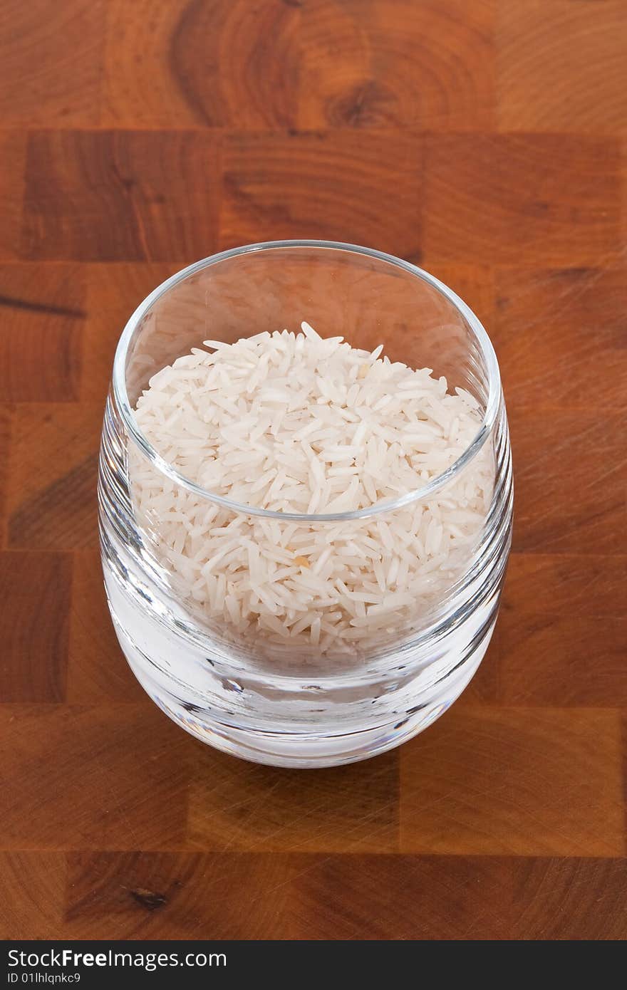 Basmati rice in glass on wooden table