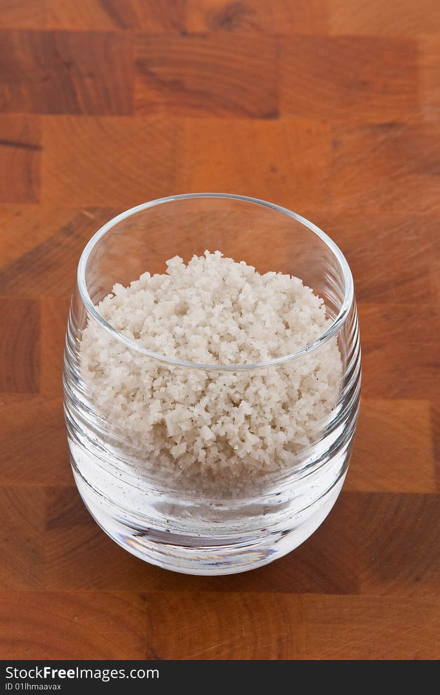 Coarse grey sea salt in glass