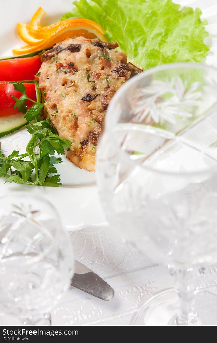 Backed meat with salad with goblet