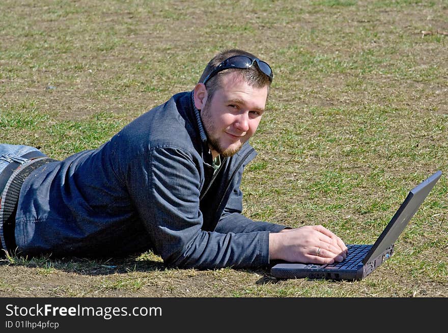 Man on meadow with laptop. Man on meadow with laptop