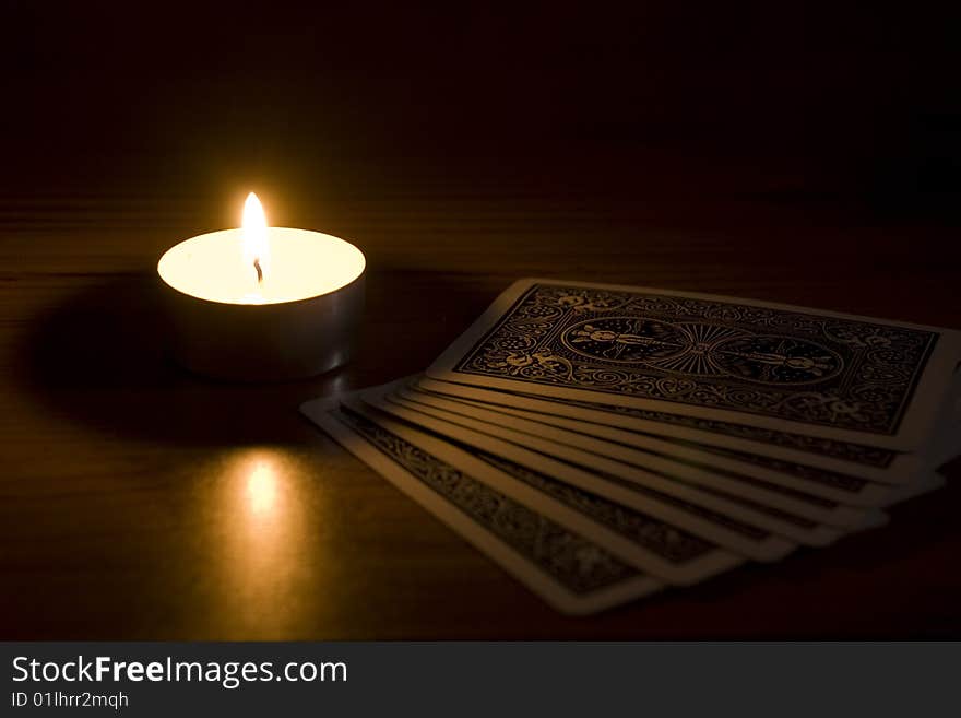 Candle with a deck of cards. Candle with a deck of cards