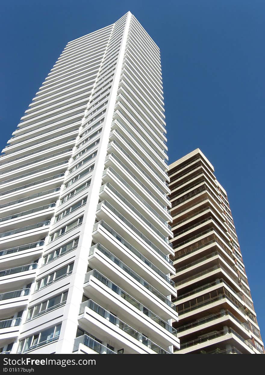 Two buildings rising upon a blue sky. Location: Rosario city, Argentina