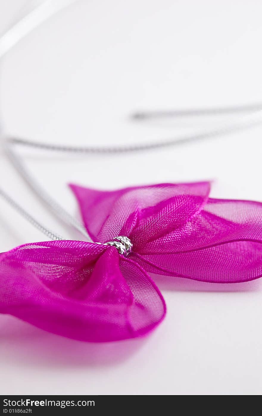 Pink bow tie ribbon with silver cord