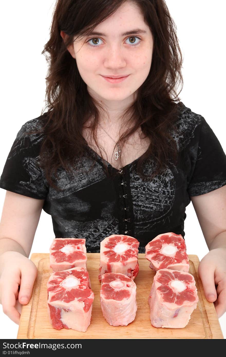 Beautiful sixteen year old girl holding cutting board of oxtails. Beautiful sixteen year old girl holding cutting board of oxtails.