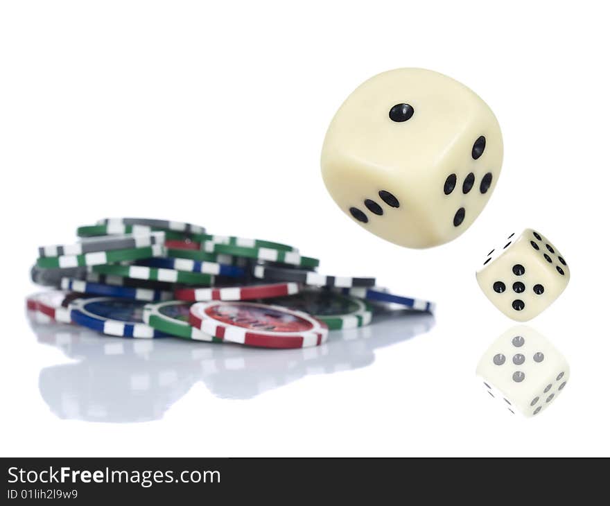 Two dices rolling beside some gambling chips. Isolated on white. Two dices rolling beside some gambling chips. Isolated on white.