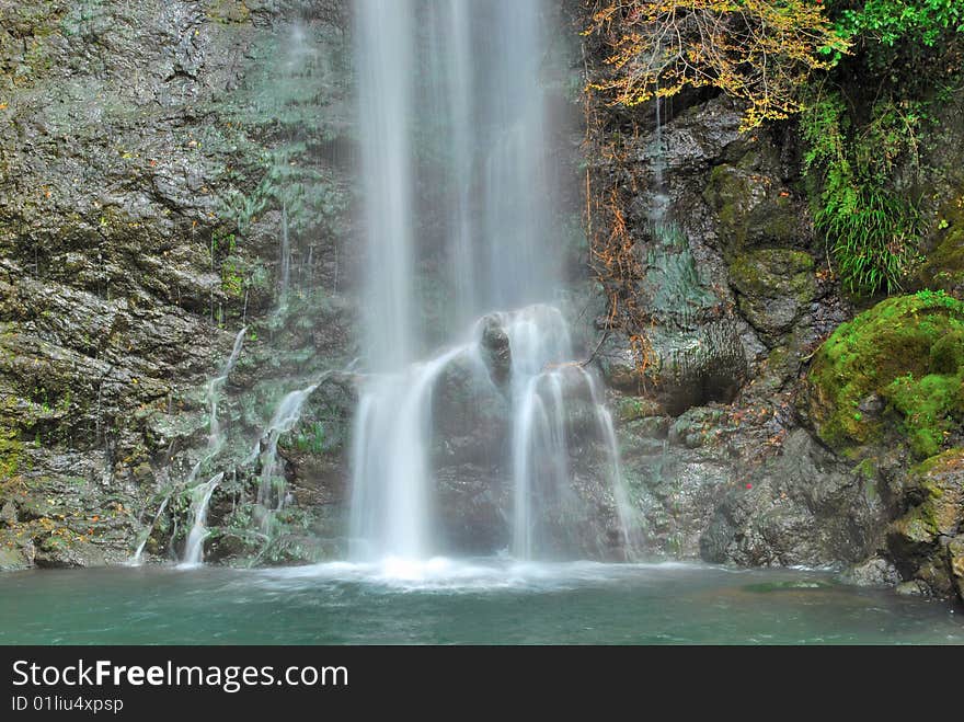 Majestic waterfall falling on rocks