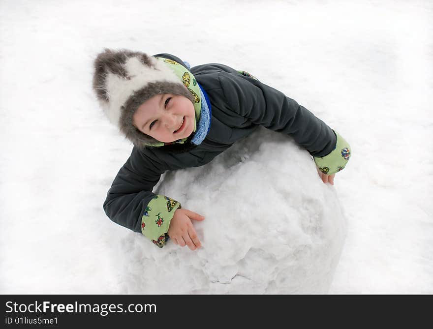 The girl in the winter on white snow with the big snow sphere. The girl in the winter on white snow with the big snow sphere