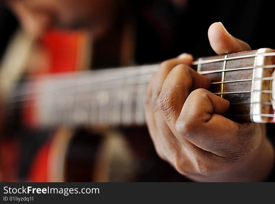 Closeup of hand playing guitar