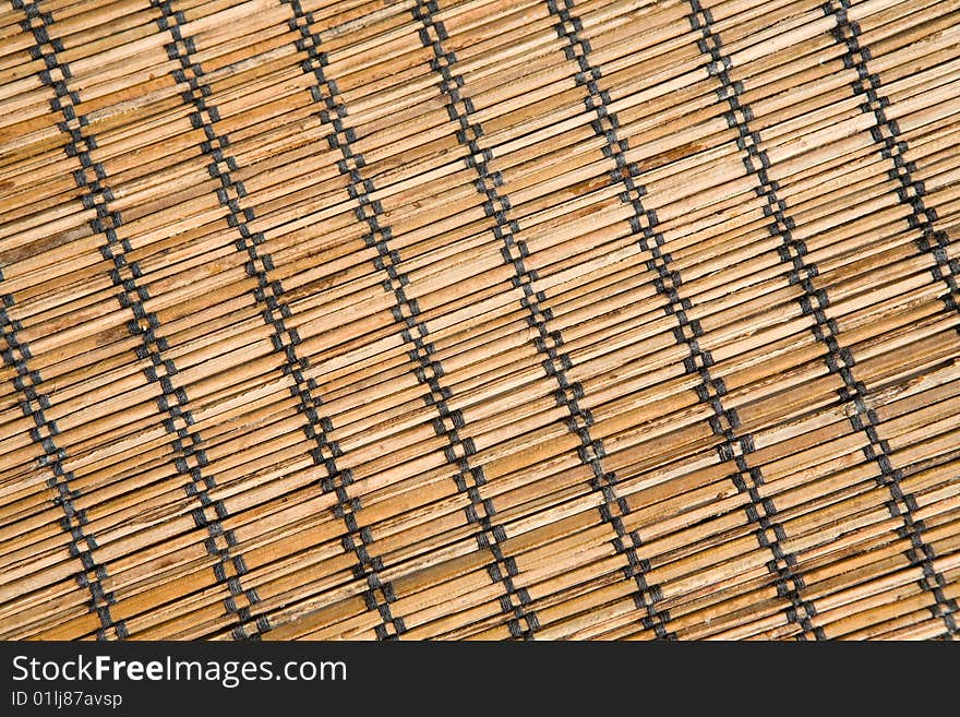 Bamboo mat with black threads texture in diagonal. Bamboo mat with black threads texture in diagonal