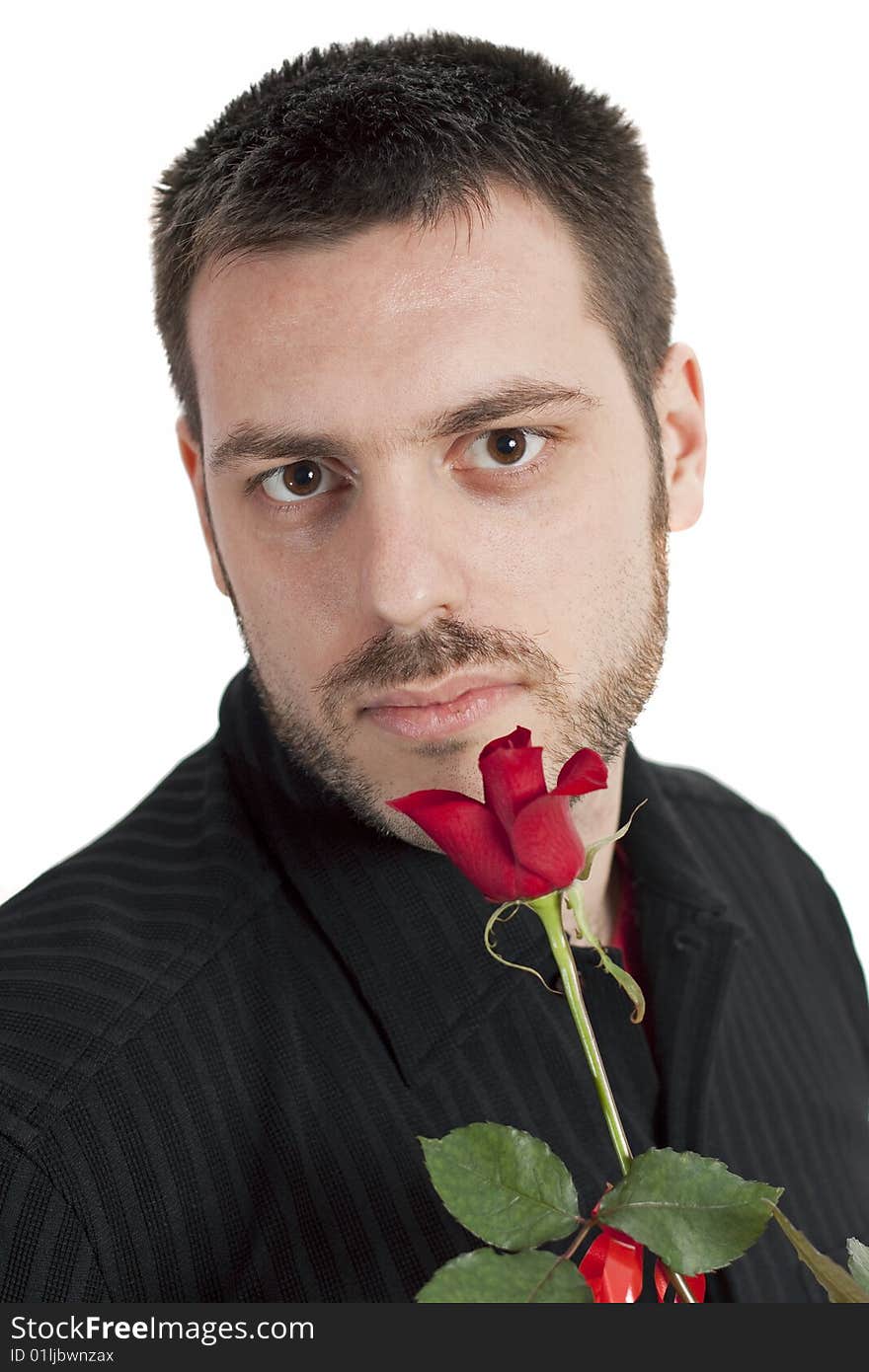 Young, handsome man, holding a beautiful red rose in his hand, looking at the camera. Young, handsome man, holding a beautiful red rose in his hand, looking at the camera