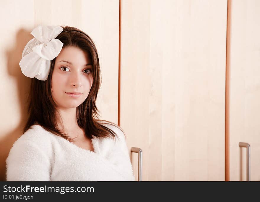 Pretty young girl with a bow in dark hair