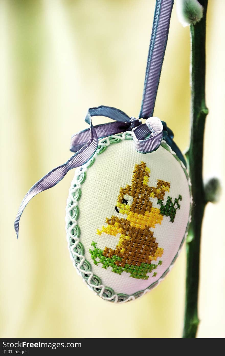 A egg is hanging on a plant, it is a decoration for easter. A egg is hanging on a plant, it is a decoration for easter