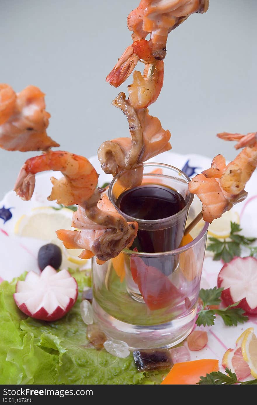 Snack from shrimps with sauce and vegetables