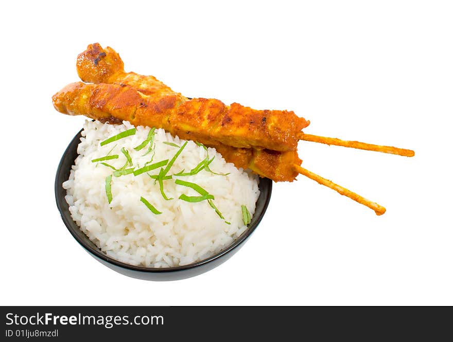 Two Chicken satay sticks with rice over white background