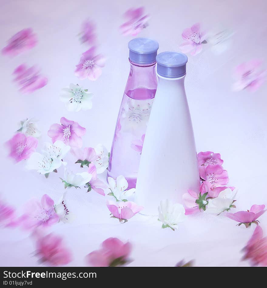 Cosmetic bottles with pink and white flowers. Cosmetic bottles with pink and white flowers