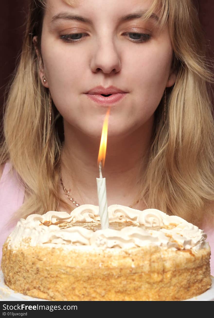 Girl blows on a candle