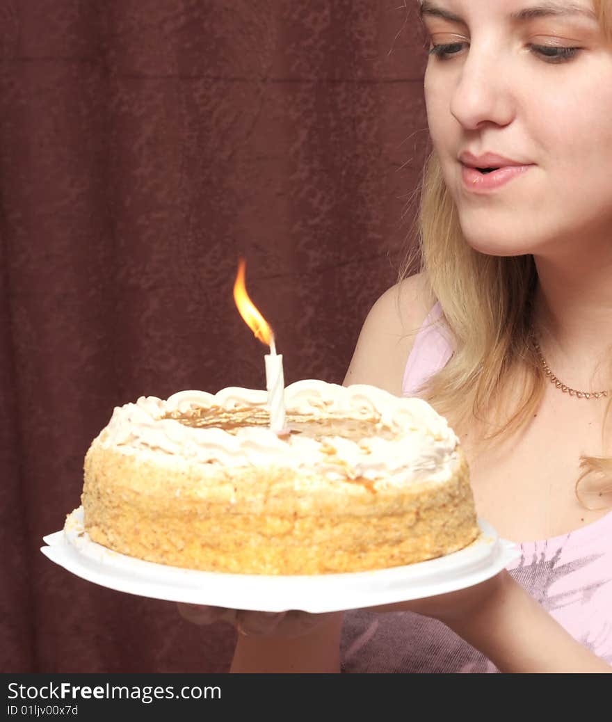 Girl blows on a candle