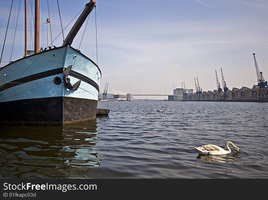 Boat In The Docks With Swans